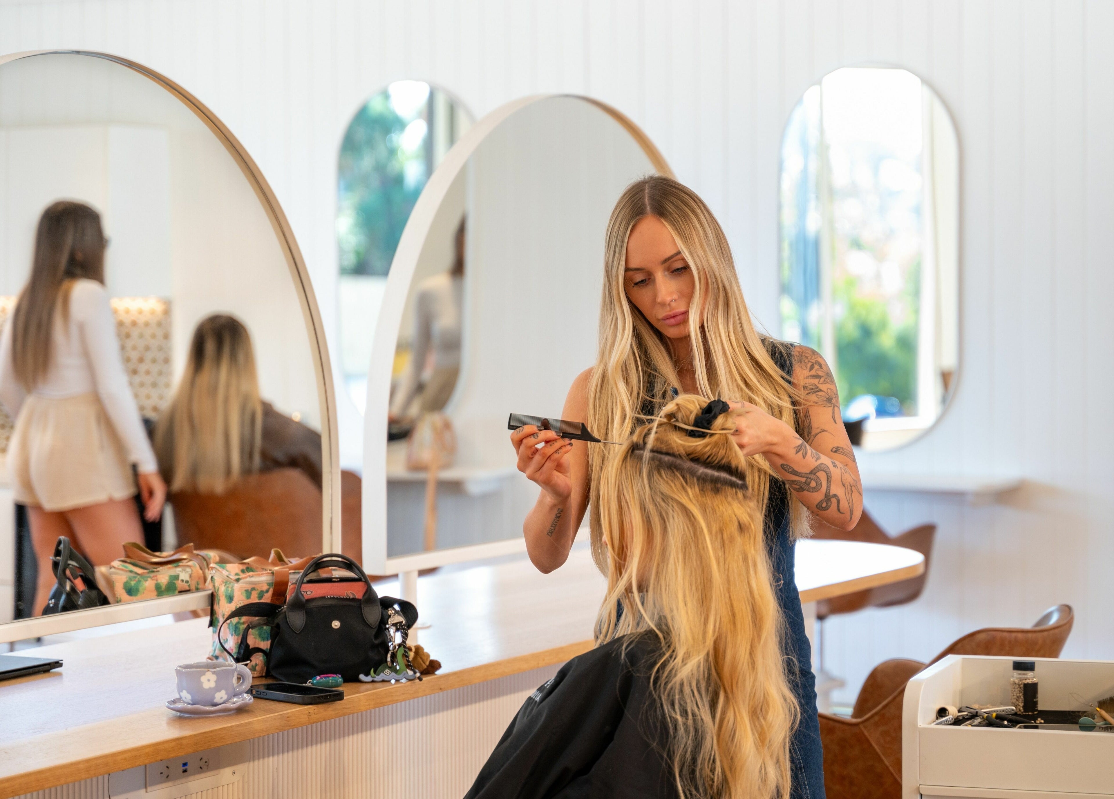 Stylist at The Mane Society in Kelvin Grove, Queensland, AU, expertly crafting a chic hairstyle.