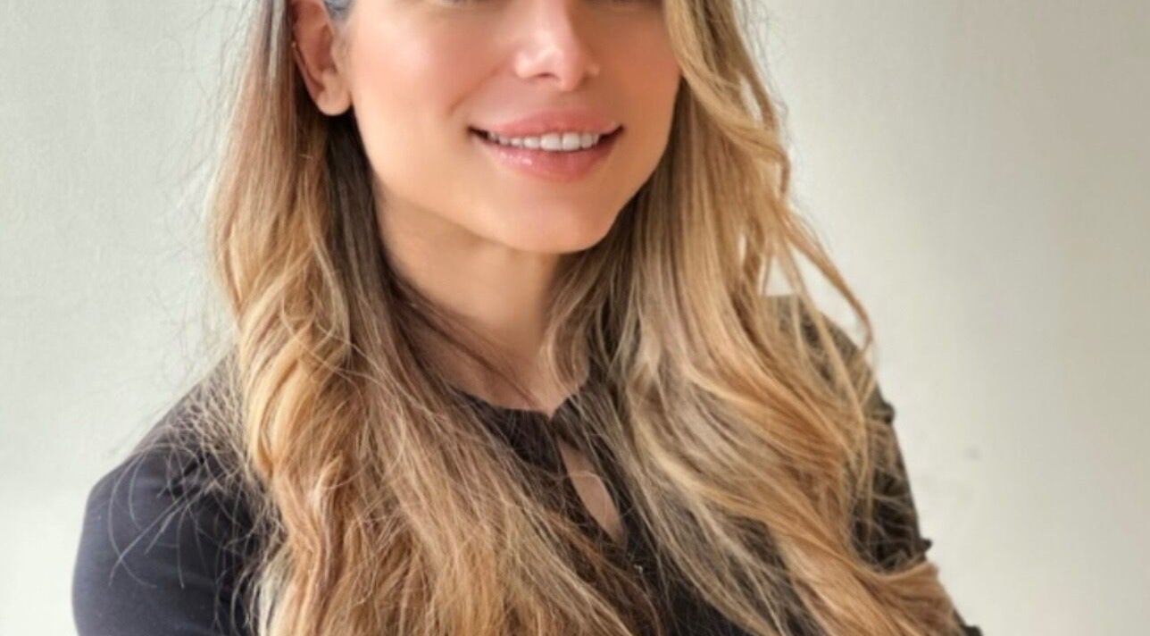 A smiling individual with styled hair at Nilou Lashes, Port Moody, British Columbia, CA.