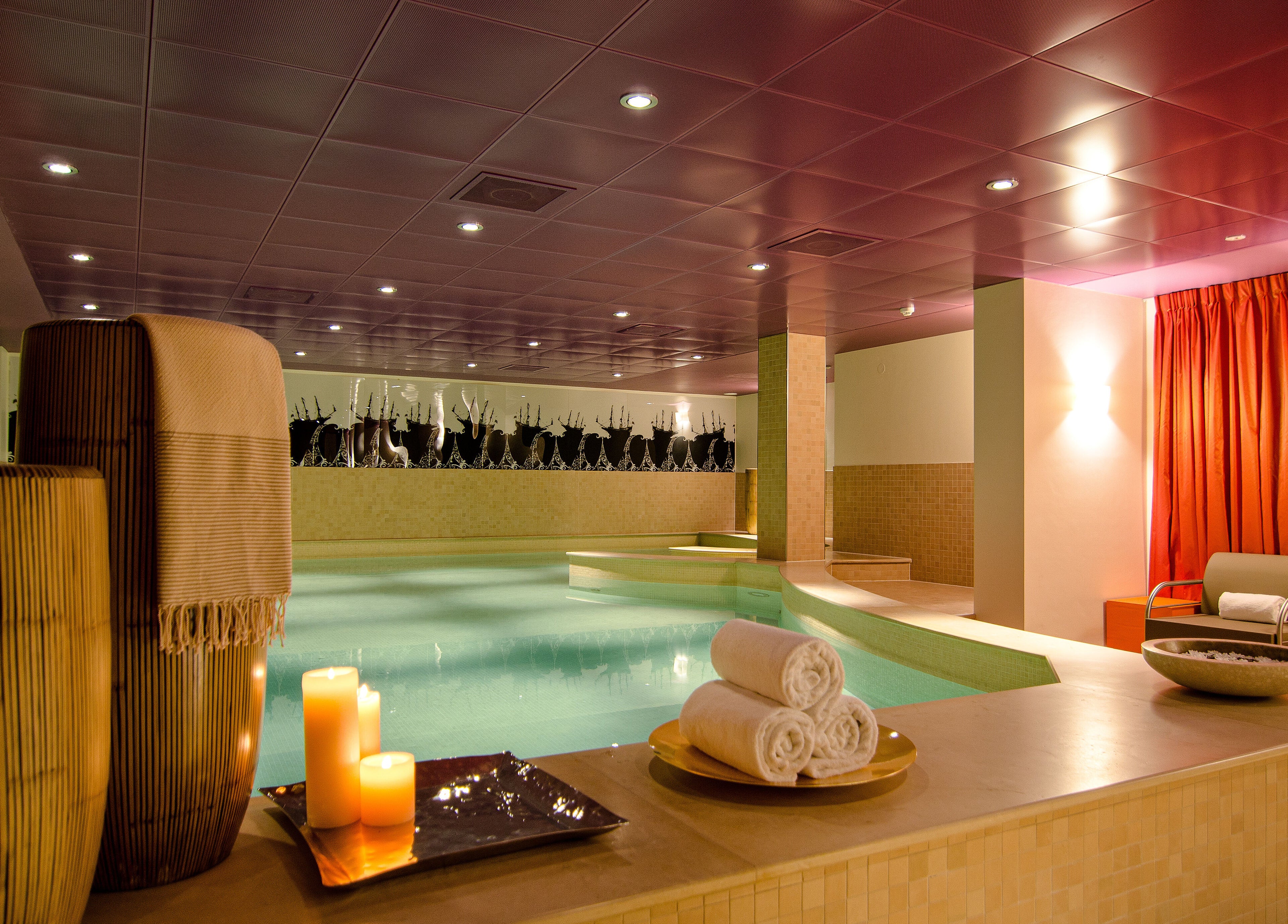 Luxurious spa area with candles and pool at Sofitel Legend The Grand Amsterdam, Noord-Holland, NL.