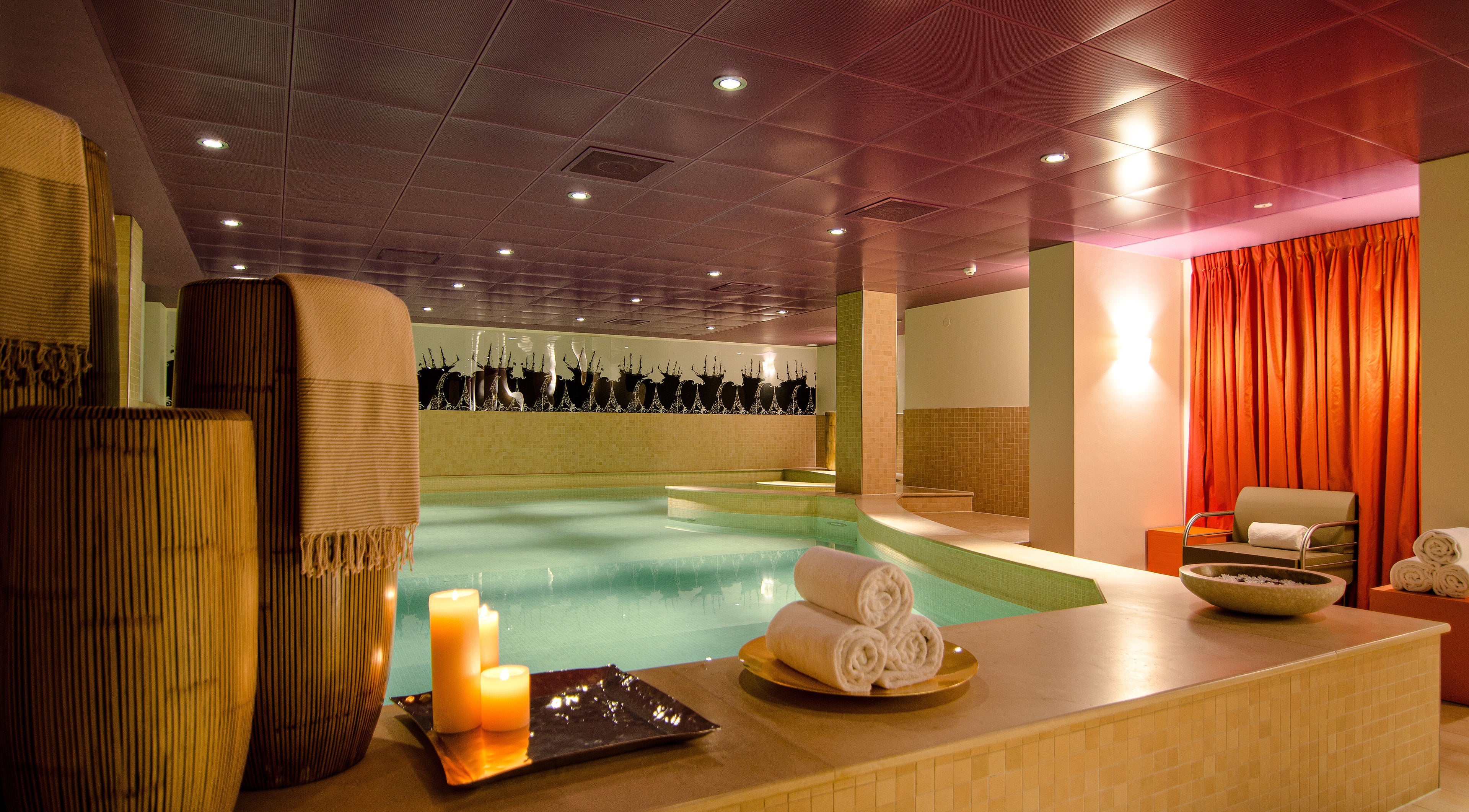 Luxurious spa area with candles and pool at Sofitel Legend The Grand Amsterdam, Noord-Holland, NL.