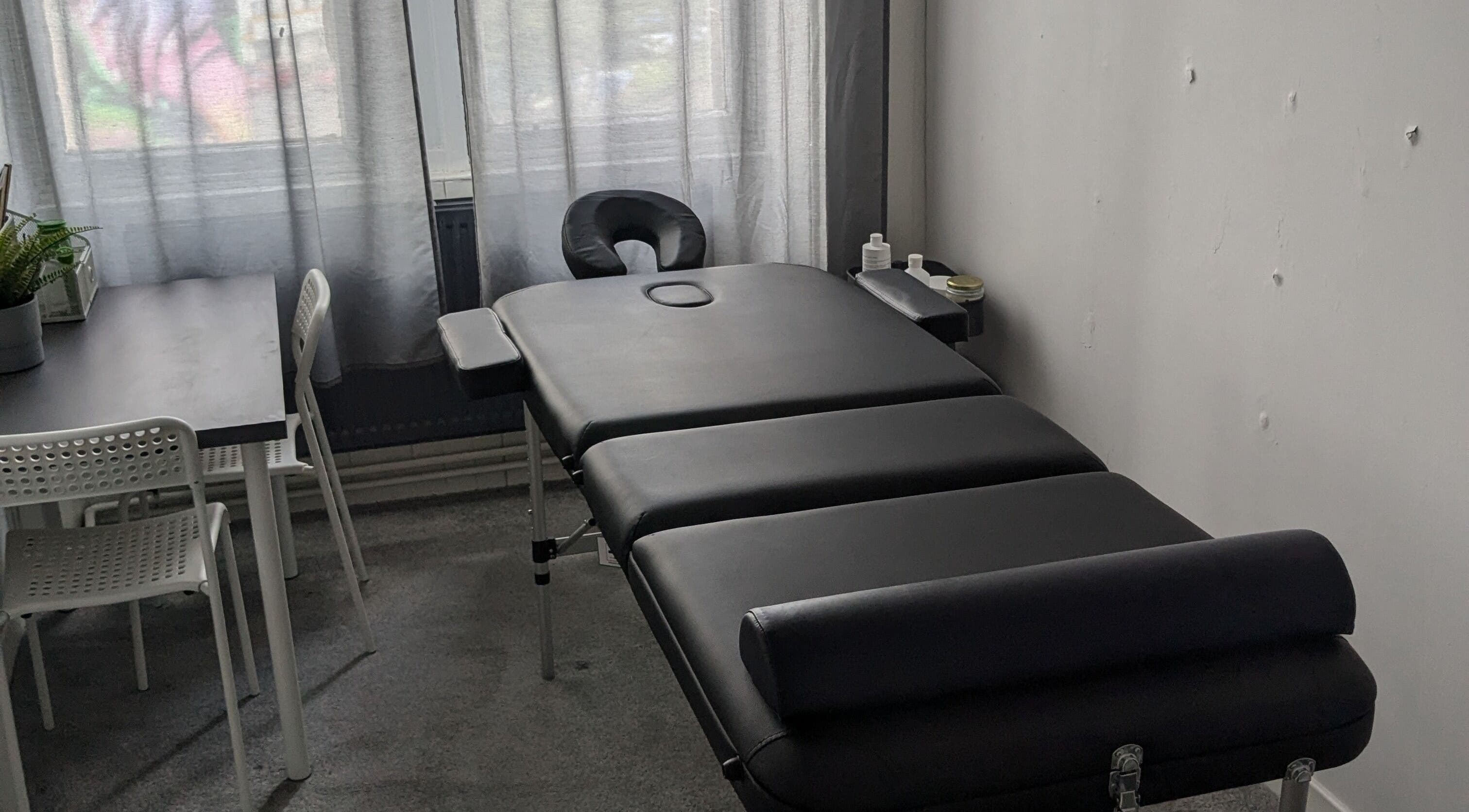 Massage table and seating area at Garry Christie Sports Massage, Glasgow, Scotland, GB.