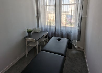 Serene massage room at Garry Christie Sports Massage, Glasgow, Scotland, GB featuring a comfortable black massage table.