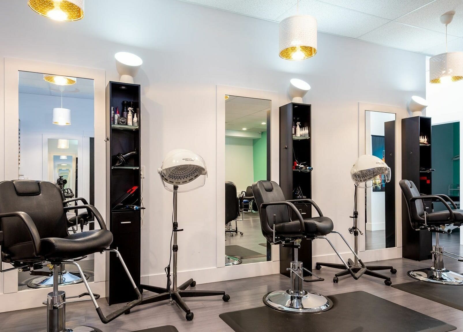 Sleek styling stations at Le Salon Dieppe, Dieppe, New Brunswick, CA, showcasing modern salon chairs and equipment.