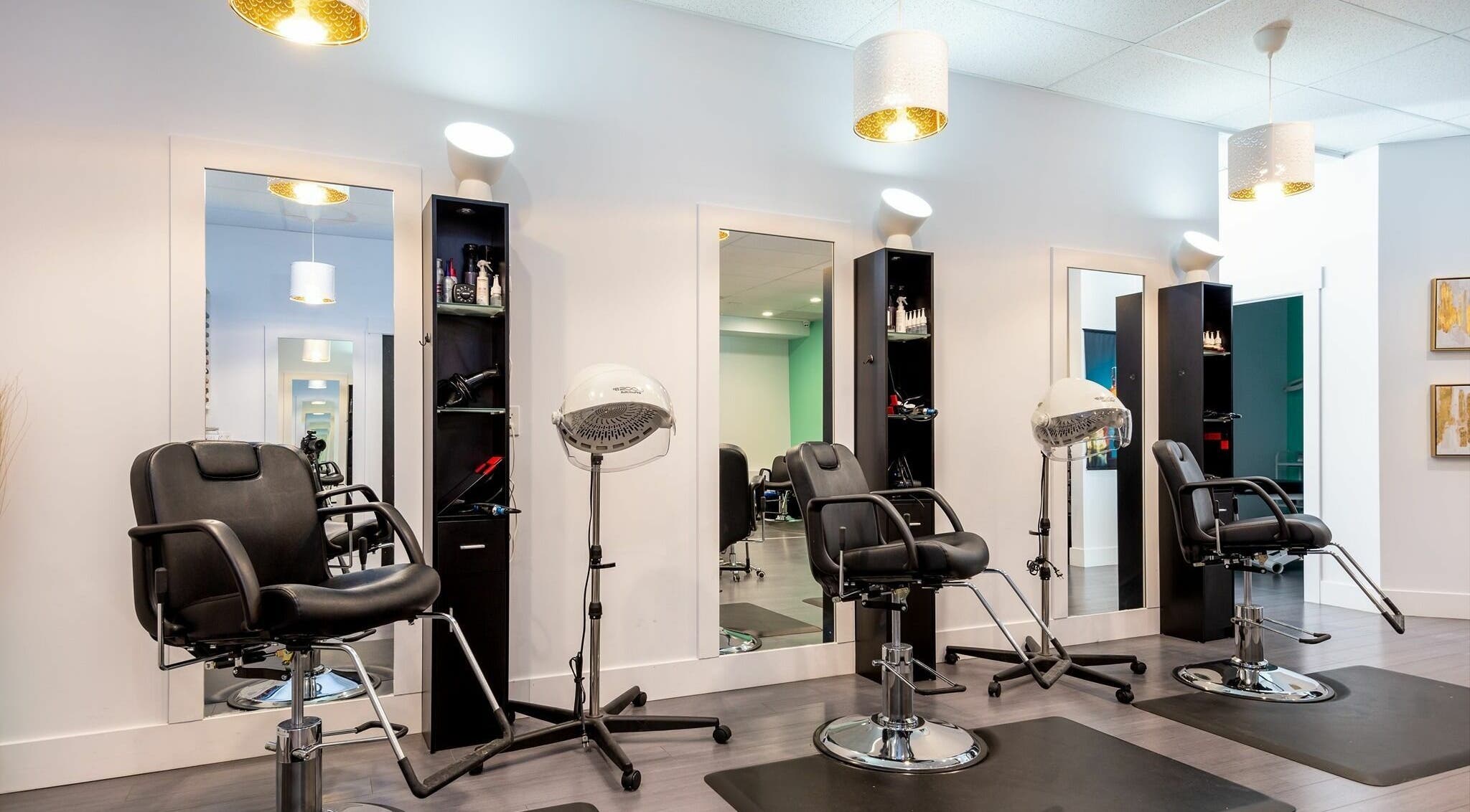 Sleek styling stations at Le Salon Dieppe, Dieppe, New Brunswick, CA, showcasing modern salon chairs and equipment.