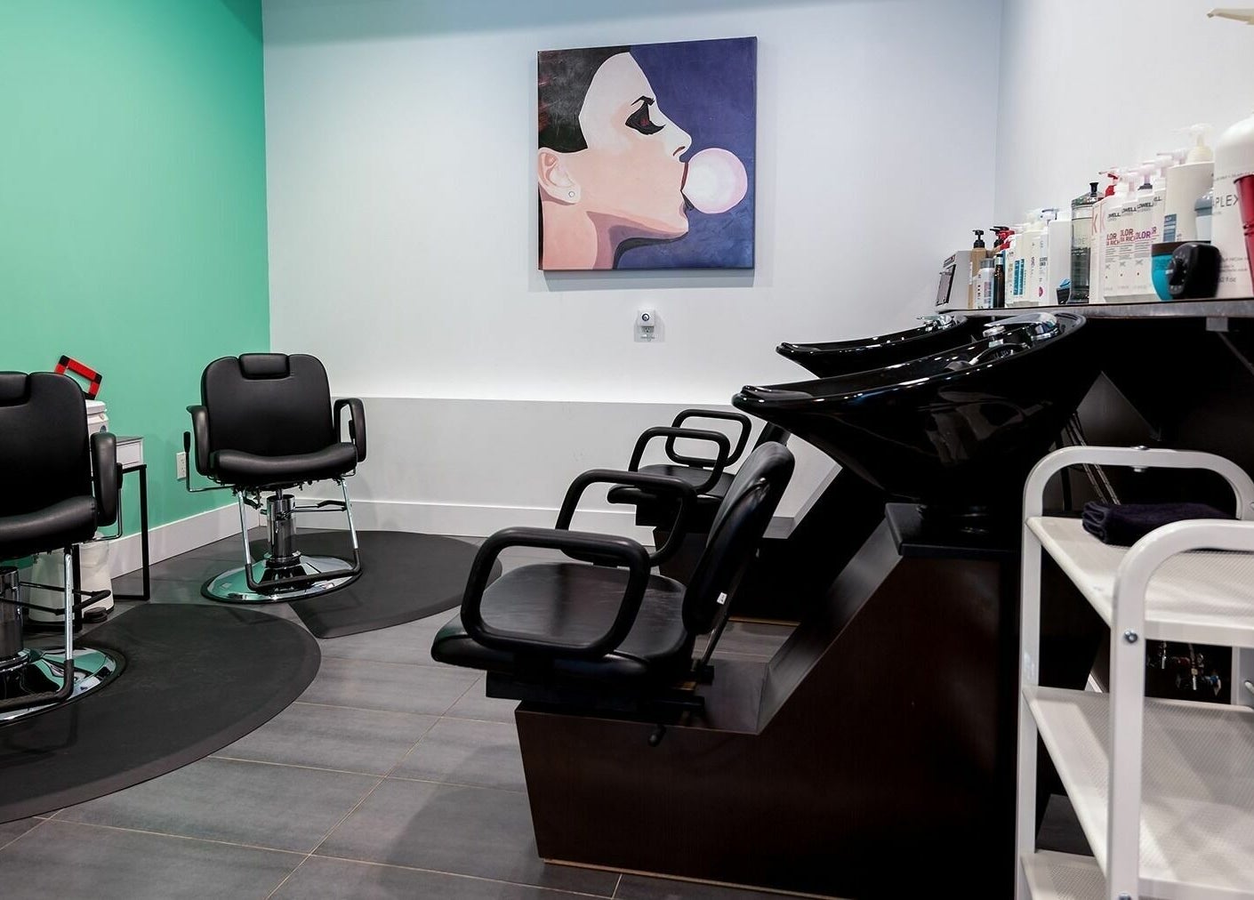 Modern salon interior at Le Salon Dieppe, Dieppe, New Brunswick, CA with stylish chairs and washstations.