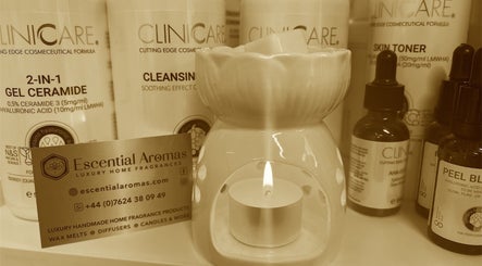 Fresh Faces in Port Erin displays skincare products and a candle, enhancing wellness ambiance.