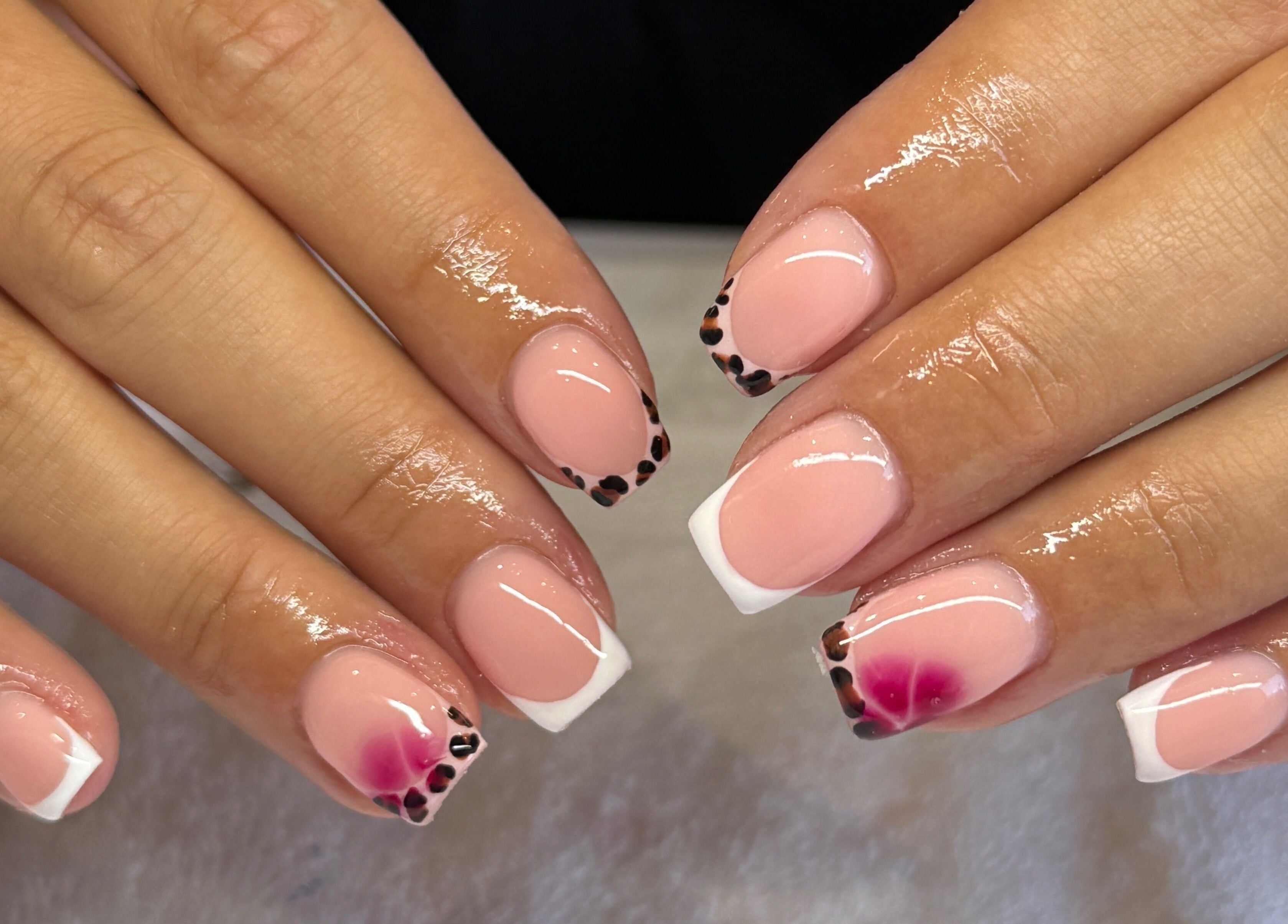 Stylish French manicured nails with floral accents at FLAWLESS - By Freya, Nuneaton, England, GB.
