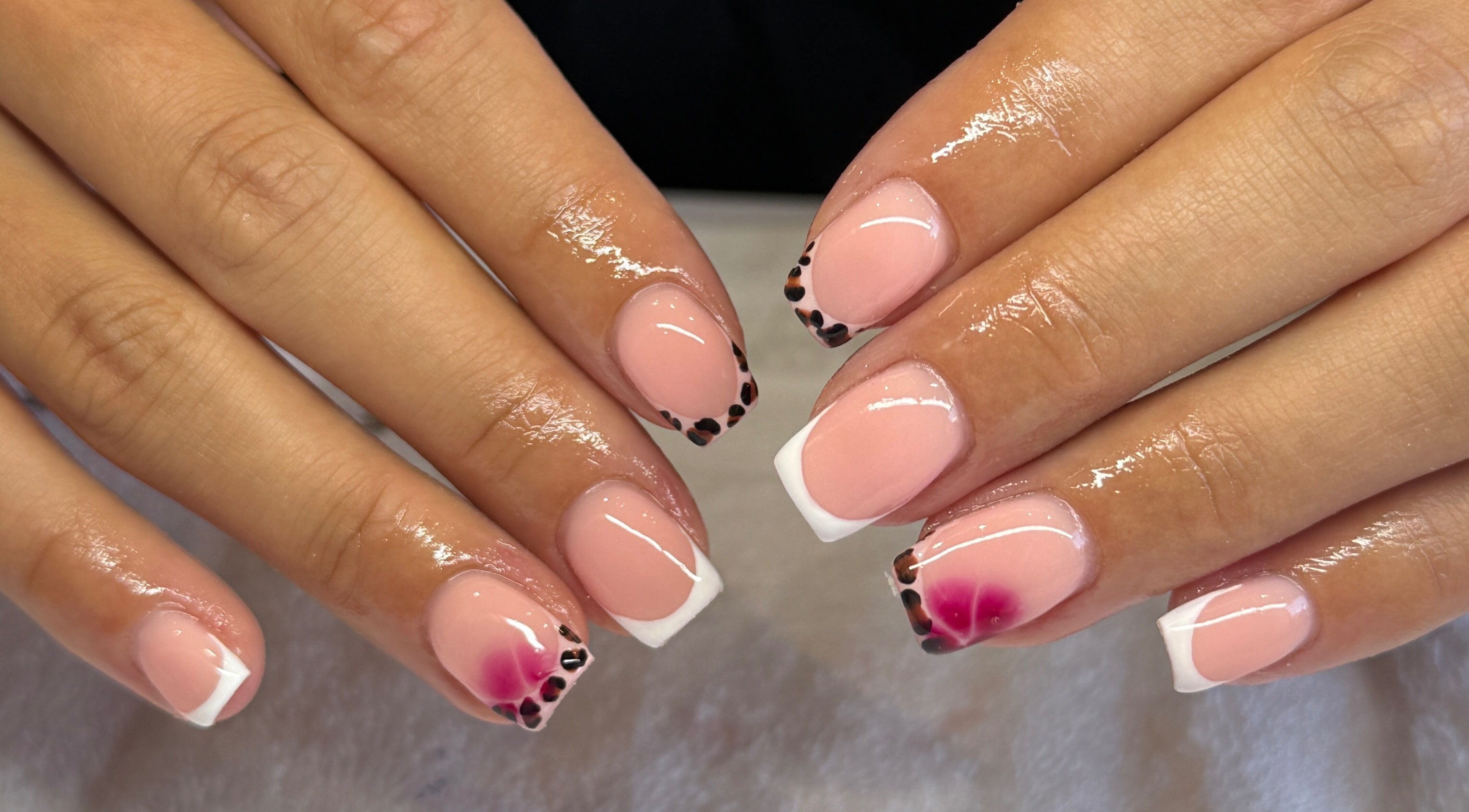 Stylish French manicured nails with floral accents at FLAWLESS - By Freya, Nuneaton, England, GB.