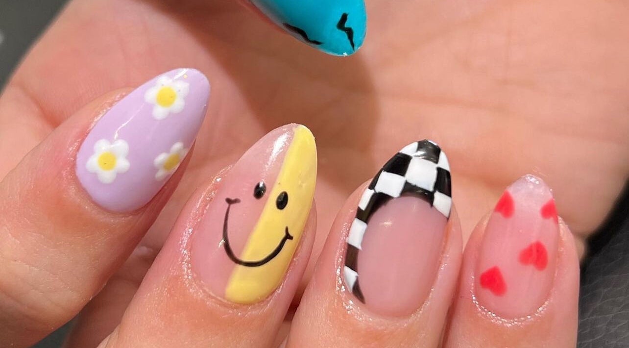 Vibrant nail designs at Buff & Bloom Treatments in Waterlooville, England, GB with floral and smiley themes.