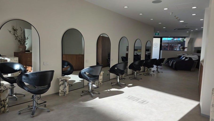 Elegant interior of Salon Lio in Crows Nest, New South Wales, AU, featuring stylish black chairs and mirrors.