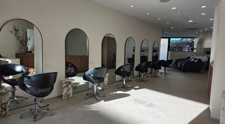 Elegant interior of Salon Lio in Crows Nest, New South Wales, AU, featuring stylish black chairs and mirrors.