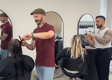 Stylists at Salon Lio, Crows Nest, New South Wales, AU, expertly cut hair in a modern setting.