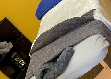 Massage bed setup in calming room at K G Beauty - Located within Enliven, Edinburgh, Scotland, GB.