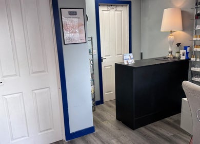 Reception area at K G Beauty - Located within Enliven, Edinburgh, Scotland, GB with elegant decor and nail polish display.