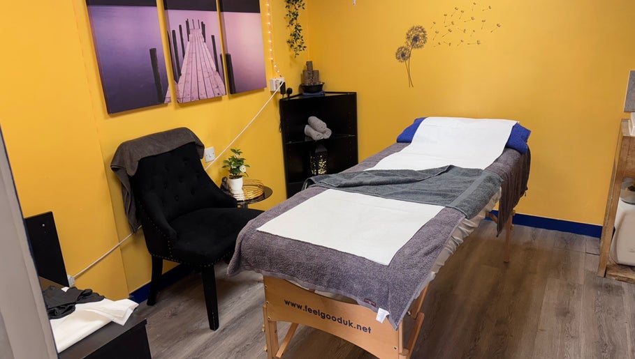 Cozy treatment room at K G Beauty, Edinburgh, Scotland, GB, featuring a massage table and black chair.