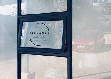 Entrance view of Elegance Health & Beauty Salon in Gqeberha, Eastern Cape, ZA, showcasing modern glass design.