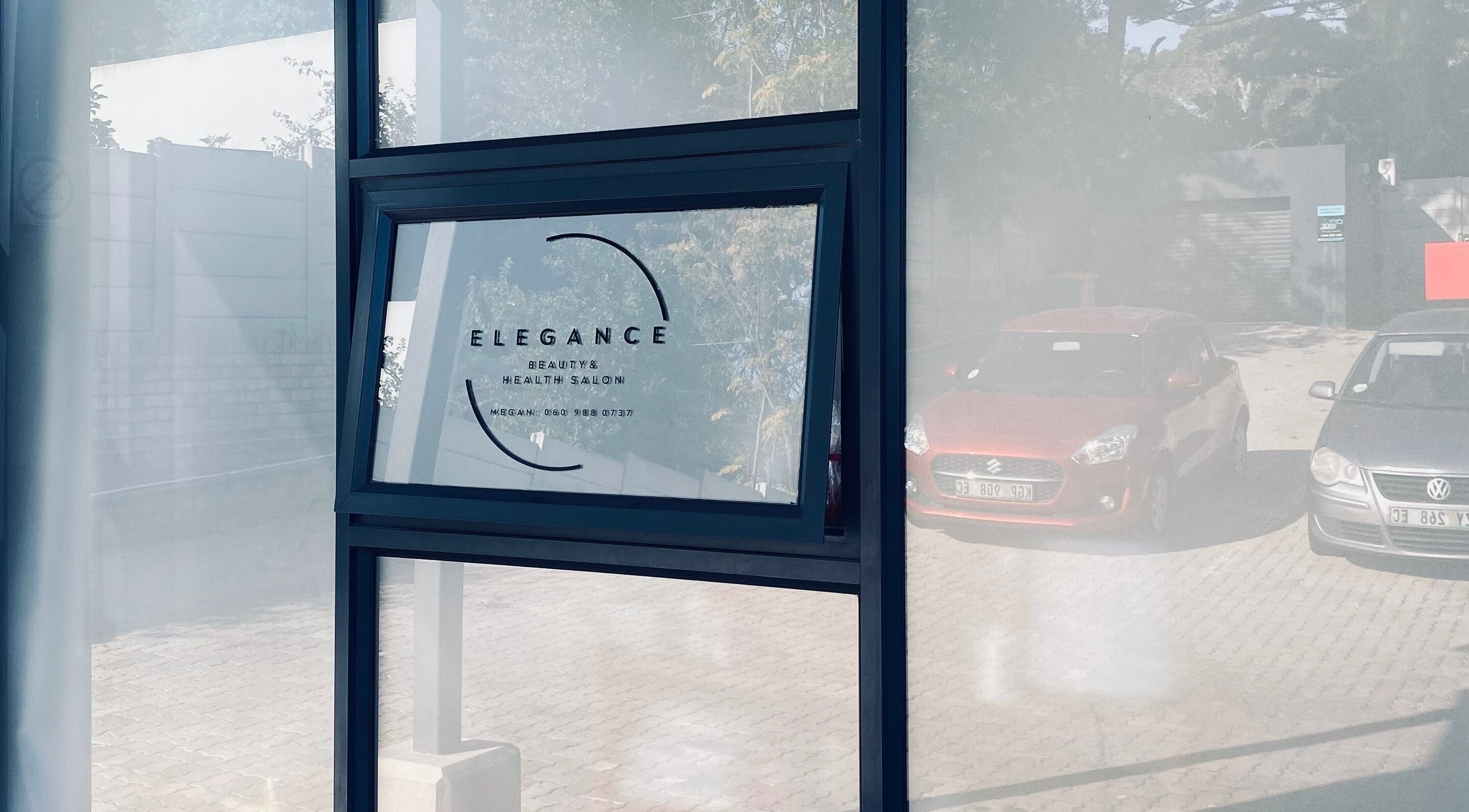 Entrance view of Elegance Health & Beauty Salon in Gqeberha, Eastern Cape, ZA, showcasing modern glass design.