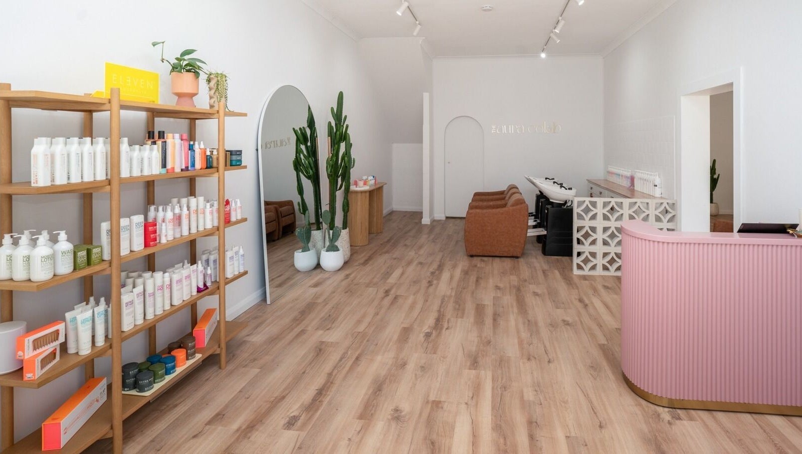 Inside The Aura Colab, Loftus, NSW, showcasing modern beauty products and chic decor in a serene setting.