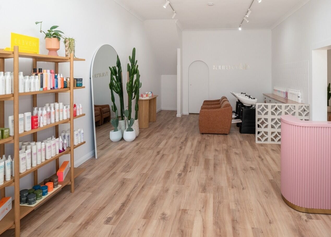 Inside The Aura Colab, Loftus, NSW, showcasing modern beauty products and chic decor in a serene setting.