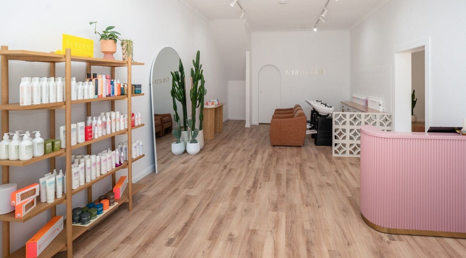 Inside The Aura Colab, Loftus, NSW, showcasing modern beauty products and chic decor in a serene setting.