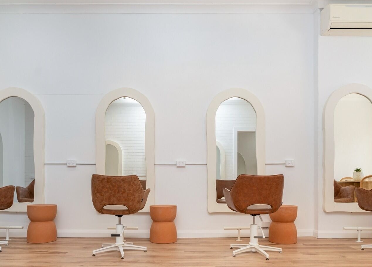 Elegant salon setup at The Aura Colab, Loftus, New South Wales, AU featuring stylish mirrors and chairs.