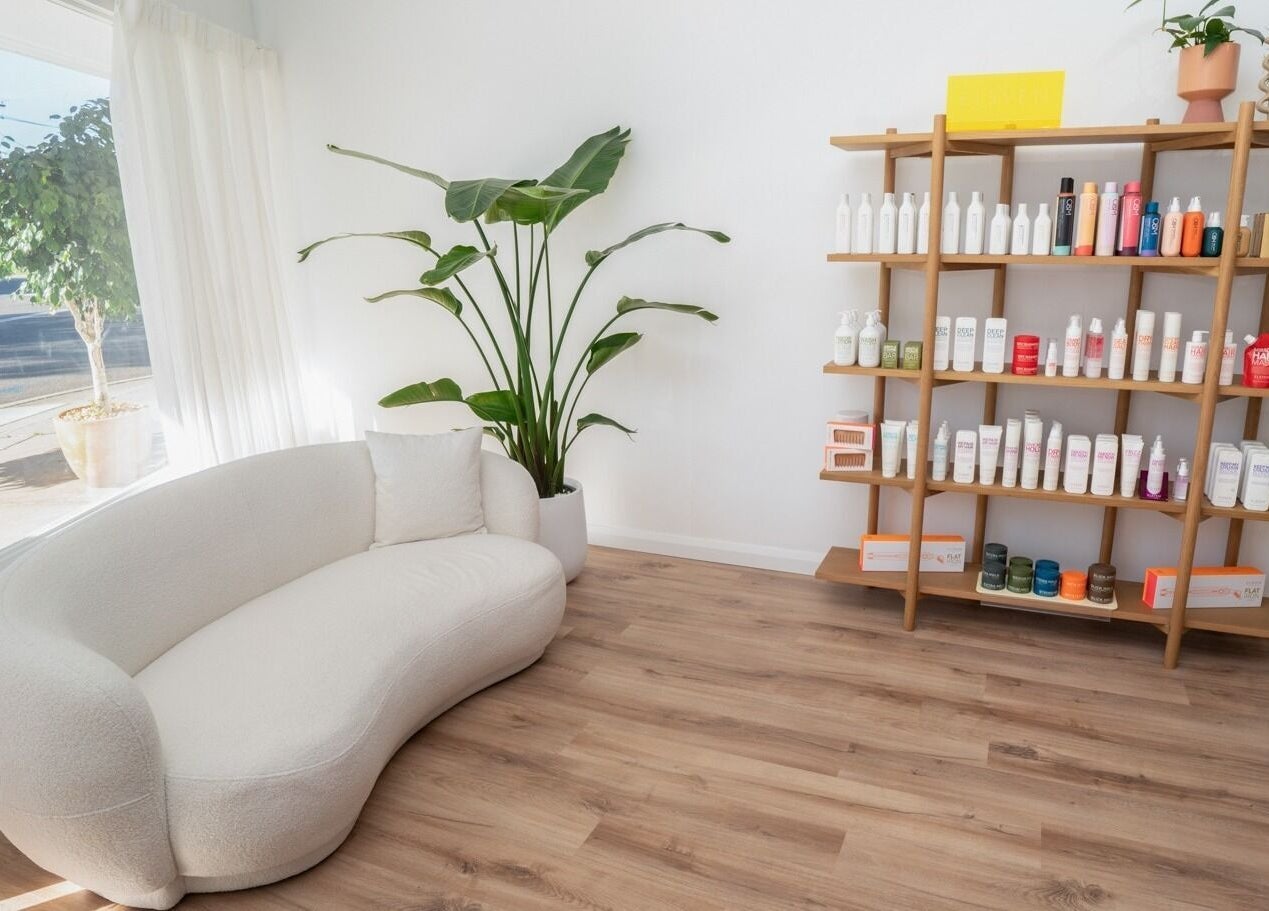 Chic product display and cozy seating at The Aura Colab, Loftus, New South Wales, AU beauty lounge.
