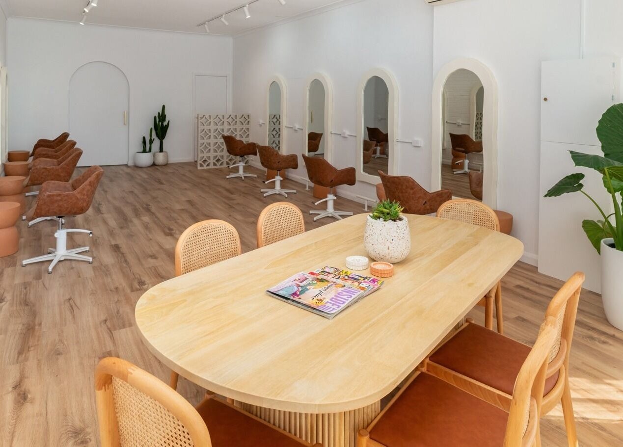Elegant salon interior at The Aura Colab, Loftus, New South Wales, AU, featuring modern chairs and stylish decor.