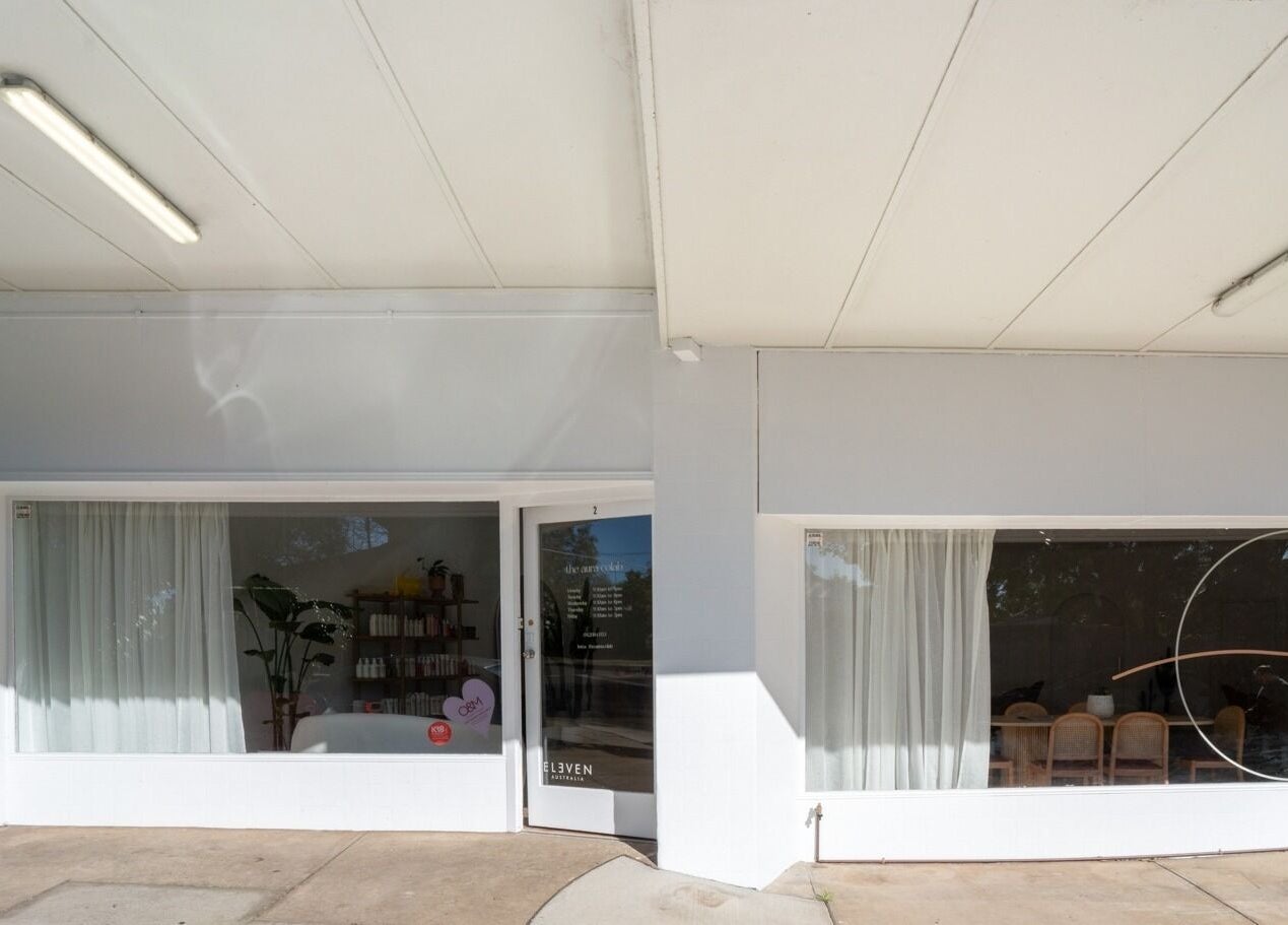 Front view of The Aura Colab, a beauty venue in Loftus, New South Wales, AU, with large windows and elegant decor.
