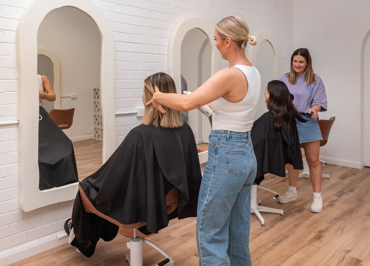 Stylists working at The Aura Colab in Loftus, New South Wales, AU creating trendy haircuts.