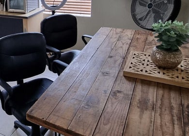 Rustic wooden table and chairs at Sam Swartz Hair in Cape Town, Western Cape, ZA, with chic decor.