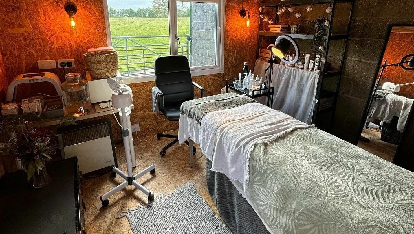Cozy treatment room at The Mulberry Tree, Radwinter, England, GB with spa bed, chair, and skincare products.