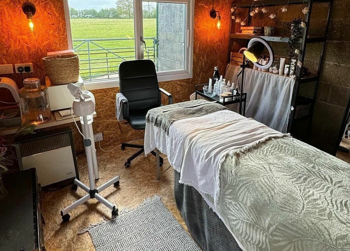Cozy treatment room at The Mulberry Tree, Radwinter, England, GB with spa bed, chair, and skincare products.