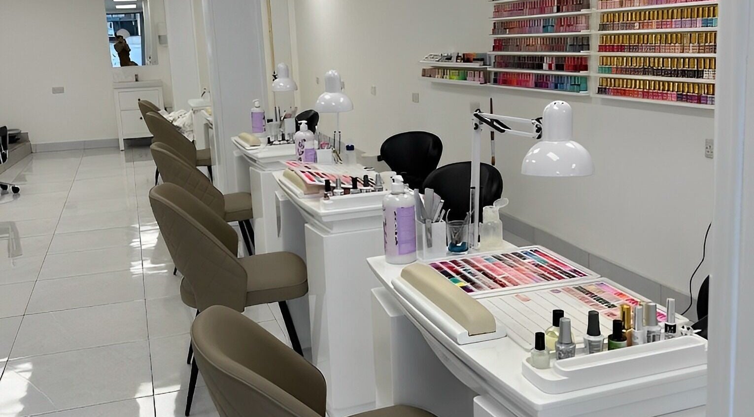 Elegant manicure stations at V Daisy nails salon, Glengormley, Northern Ireland, GB showcasing vibrant nail polishes.
