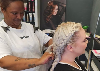 Stylist braiding hair at Fabulaze Beauty Studio, Cape Town, Western Cape, ZA, creating a stunning look.