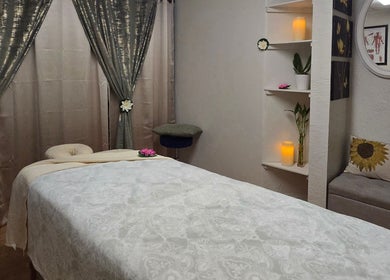 Calm massage room at Chaba Thai Massage LLC in Bethesda, MD with a cozy bed and soothing decor.