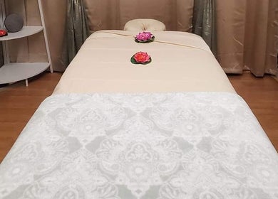 Elegant massage table setup at Chaba Thai Massage LLC, Bethesda, MD, US, with floral accents.