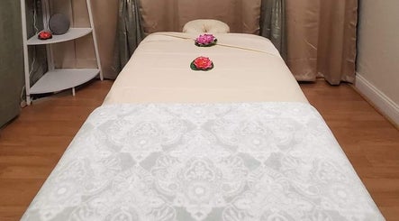 Elegant massage table setup at Chaba Thai Massage LLC, Bethesda, MD, US, with floral accents.