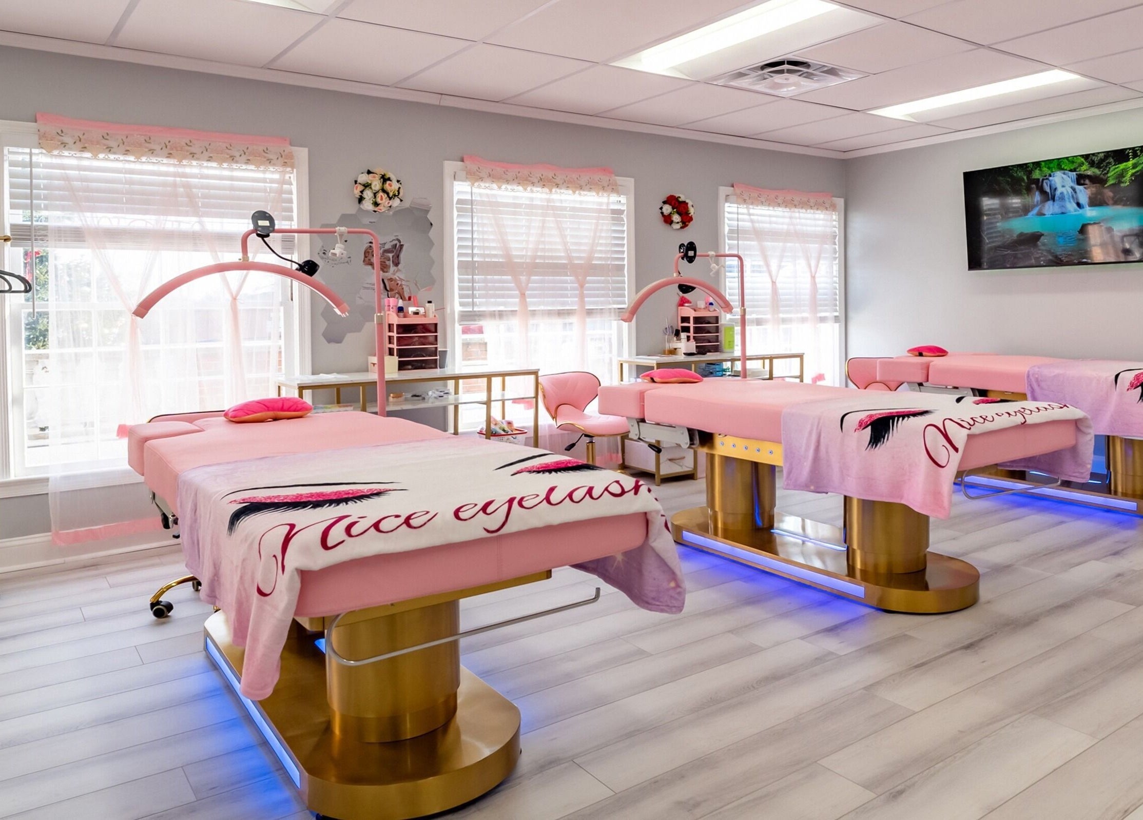Elegant spa treatment room at Lash and Spa ByNeda in Vienna, VA, US with pink decor and cozy beds.