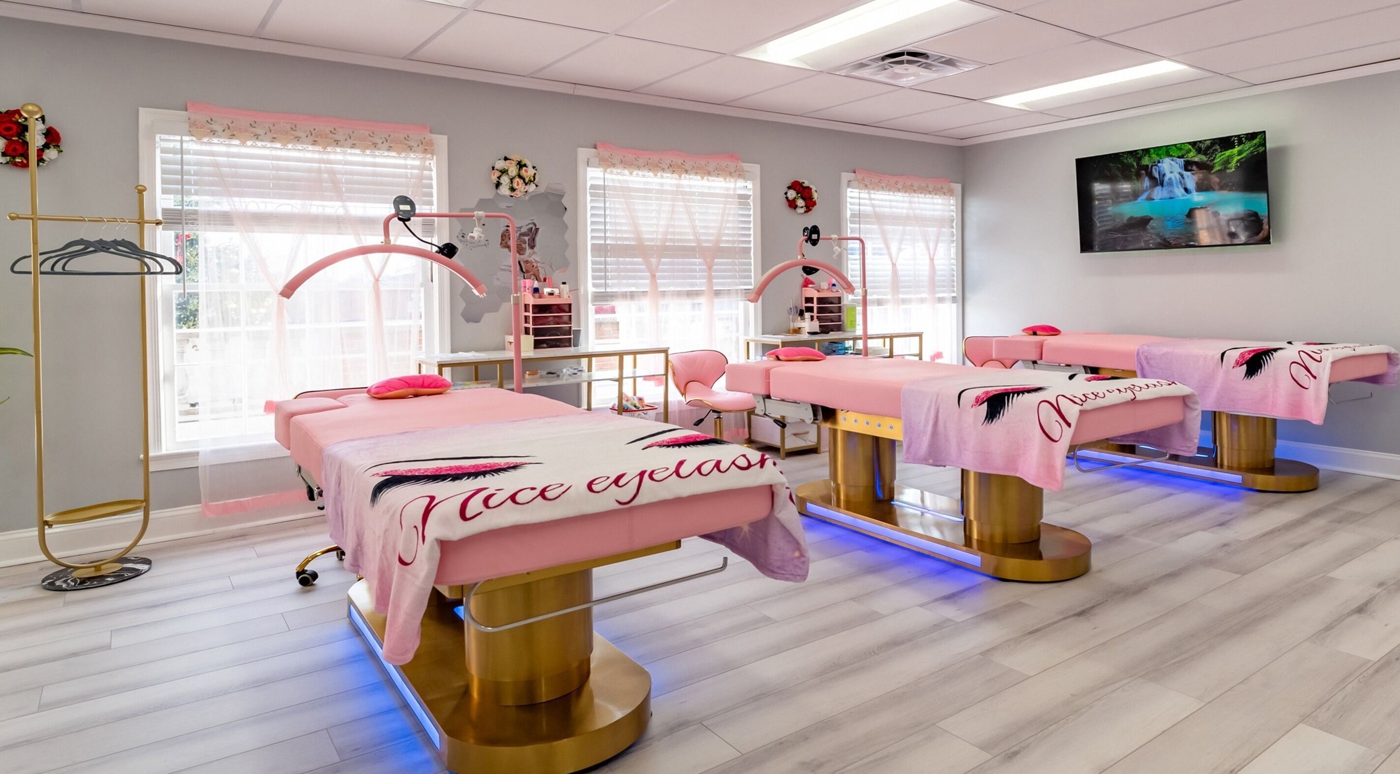 Elegant spa treatment room at Lash and Spa ByNeda in Vienna, VA, US with pink decor and cozy beds.
