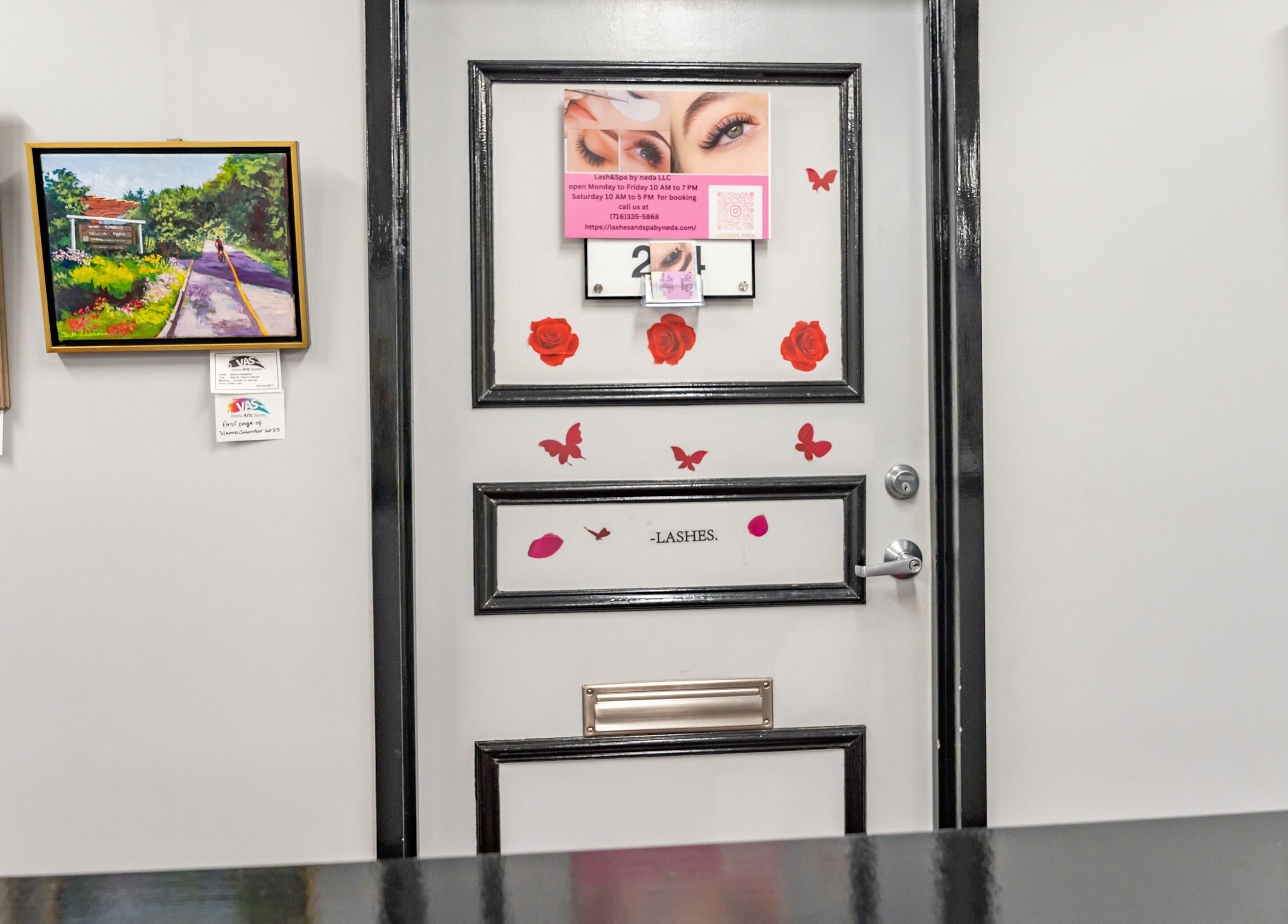 Decorated door at Lash and Spa ByNeda, Vienna, VA, US with art and butterfly stickers.