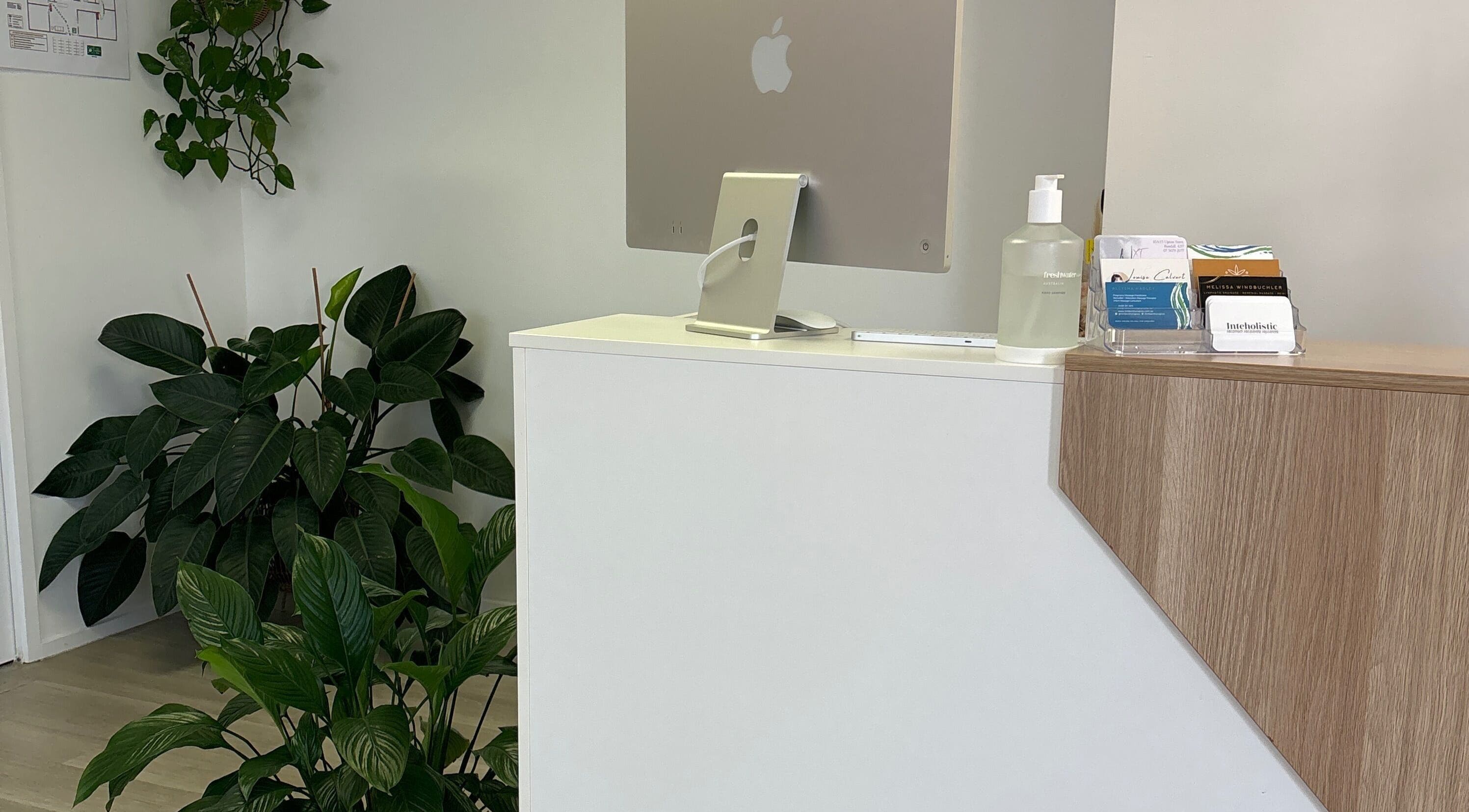 Reception area at Nxt Level Integrated Health Pty Ltd in Bundall, Queensland, AU adorned with lush greenery.