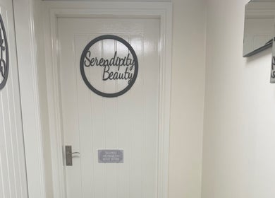 Entrance of Serendipity Beauty in Douglas, GB with stylish door sign.