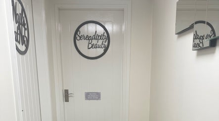 Entrance of Serendipity Beauty in Douglas, GB with stylish door sign.