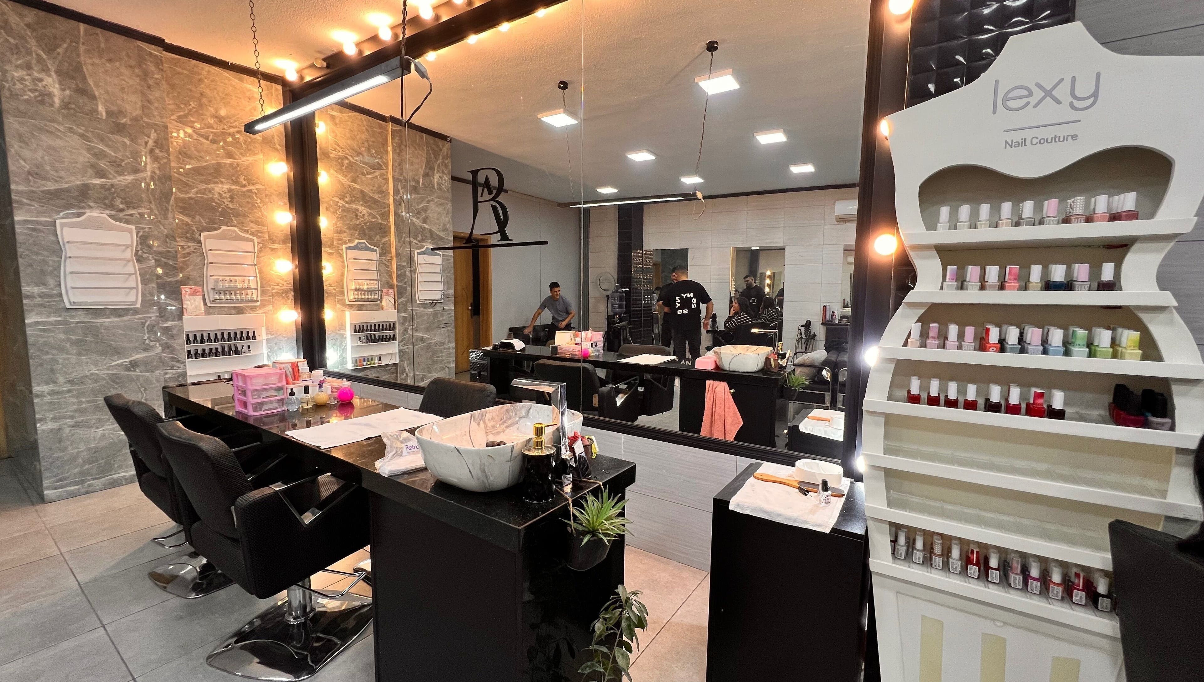 Elegant nail studio at Nisreenailss in Jabal Lubnan, Jabal Lubnan, LB with modern decor and nail polish display.