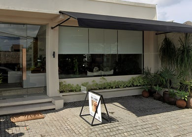 Entrance of Sounds Of Sun, Bali, Bali, ID, featuring lush greenery and modern glass facade.