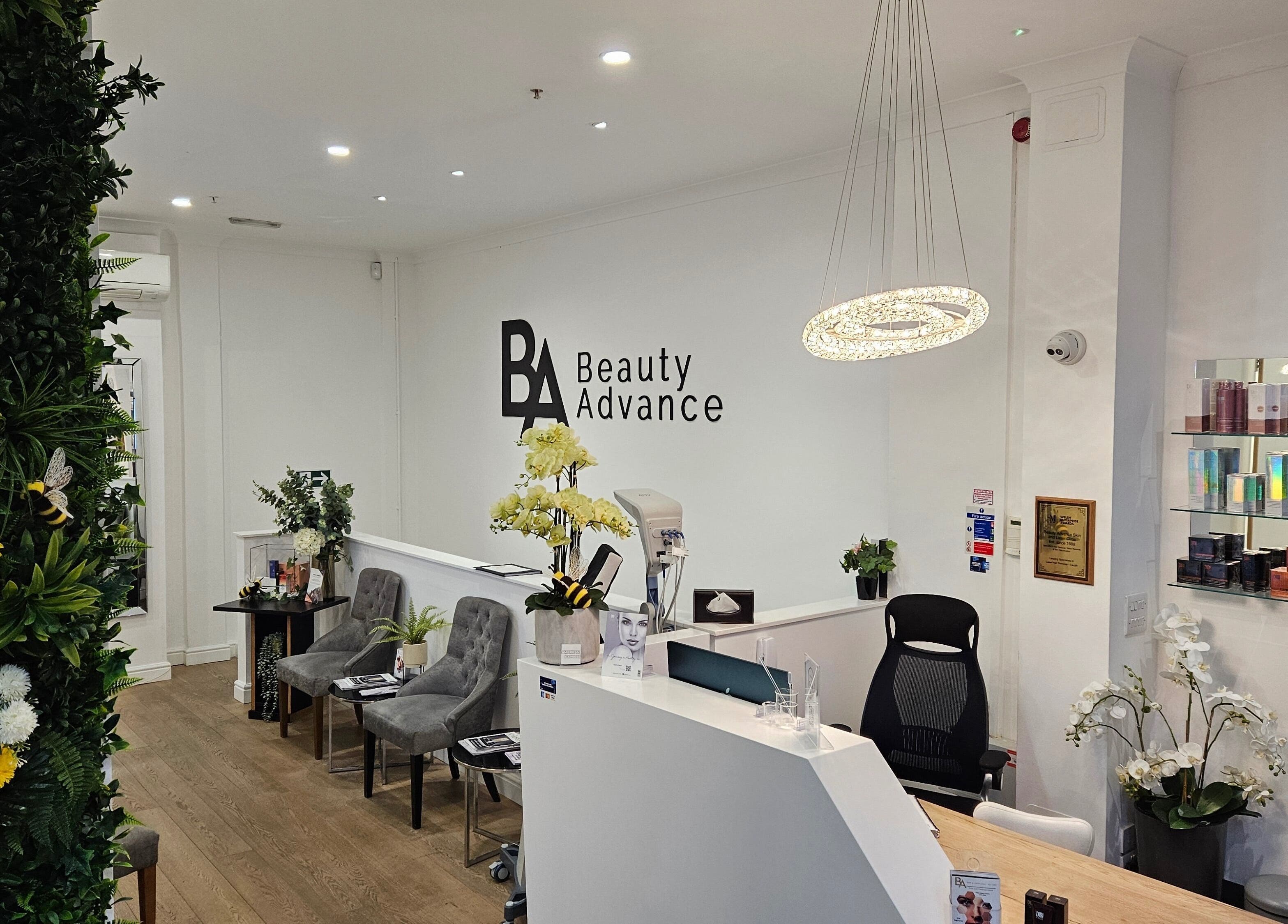 Reception area at Beauty Advance Skin & Laser Clinic, Cardiff, Wales, GB with floral decor and luxury products.