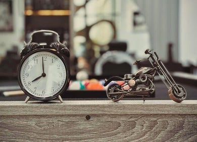 Retro clock and mini motorcycle decor at Royal Shave Barber, Dubai, AE.