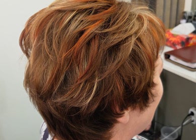 Stylish short hairstyle with highlights at Salon@735 in Pretoria, Gauteng, ZA.