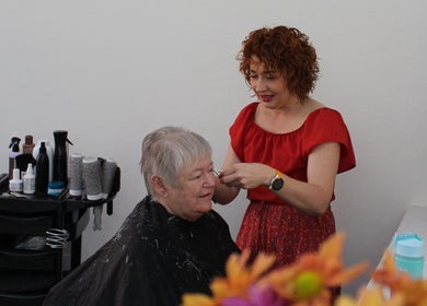 Stylist at Salon@735 in Pretoria, Gauteng, ZA, attending to a happy elderly client.