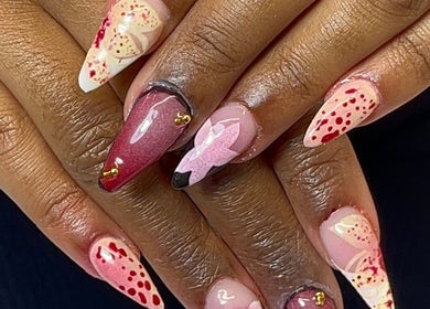 Creative nail art with red and pink designs at Nail Kulture, Rochdale, England, GB.